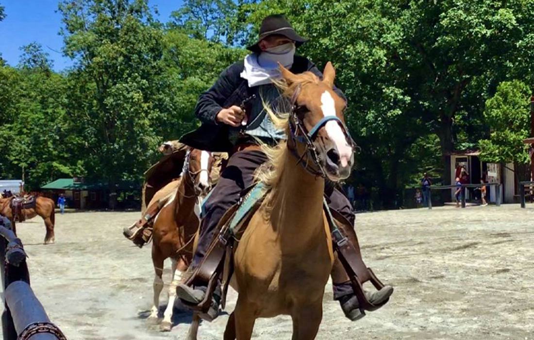 Cowboy on horseback performing at Wild West City, showcasing an interactive western experience in Sussex County, New Jersey.