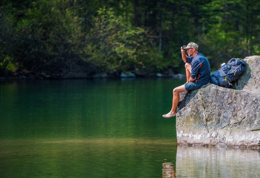 Camping at Panther Lake Camping Resort Hiker sitting overlooking lake