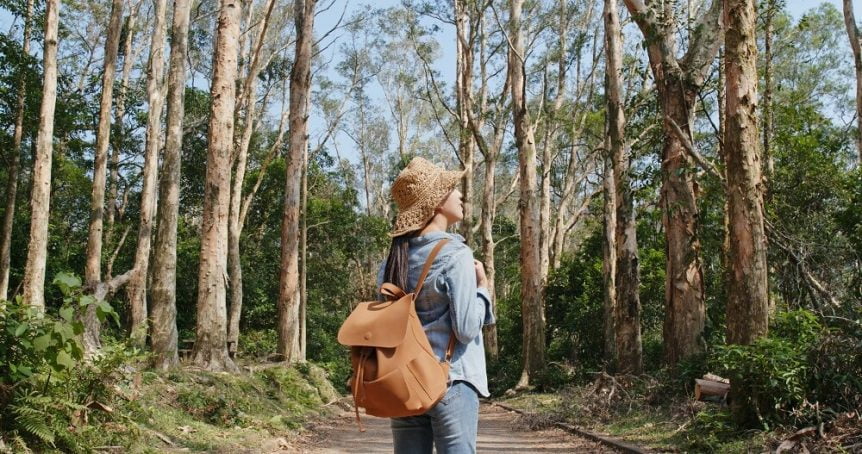Woman on path between trees